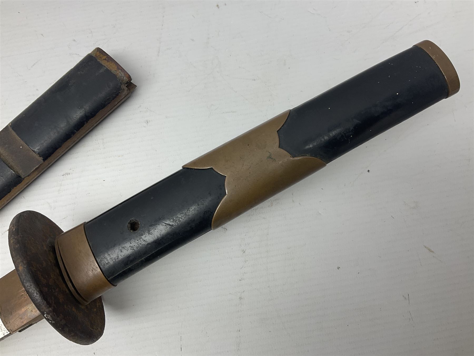 Good quality Japanese sword blade with later WWII fittings and scabbard  - 67.5cm slightly curving blade with unmarked tang, plain iron tsuba and lacquered grip with copper mounts; in lacquered wooden scabbard with tape bound tip L94cm overall