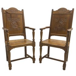 Pair of 17th century design oak open armchairs, the shaped cresting rail carved with oval leaf motif, panelled back carved with mask and foliage, moulded plank seat on turned supports united by H-shaped stretchers 