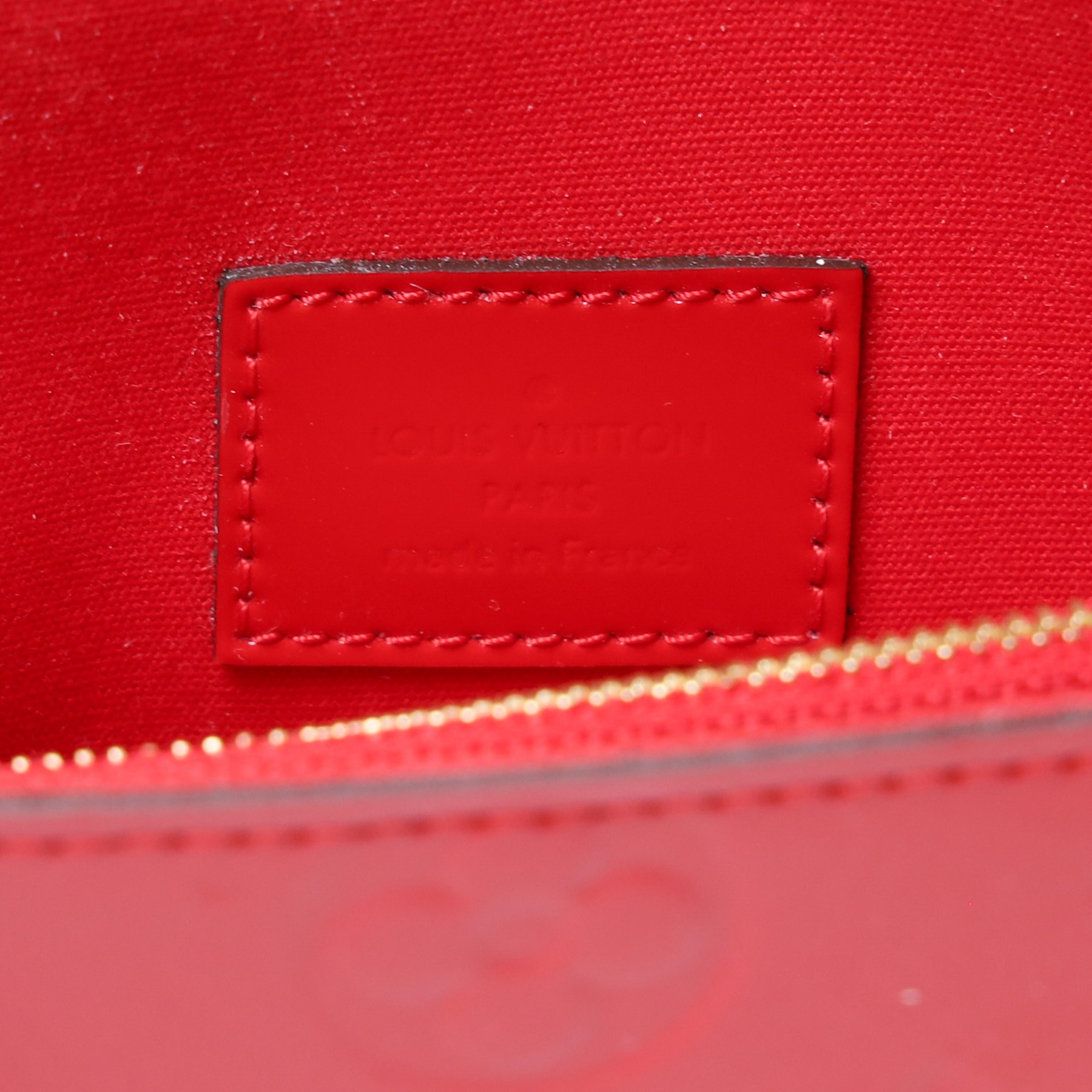 Louis Vuitton - ‘Lucy’ pochette in Cerise red Monogram Vernis leather, the structured envelope-form body with gold-tone press-stud fastening, opening to a red fabric-lined interior with central zipped compartment and two gusseted open pockets, with care card, dust bag and box