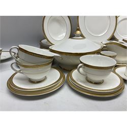 Royal Doulton Royal Gold pattern tea and dinner service for eight, comprising dinner plates, side plates, tea plates, soup bowls, sauce boat and saucer, dessert bowls, coffee cans and saucers, teacups and saucers and two lidded tureens