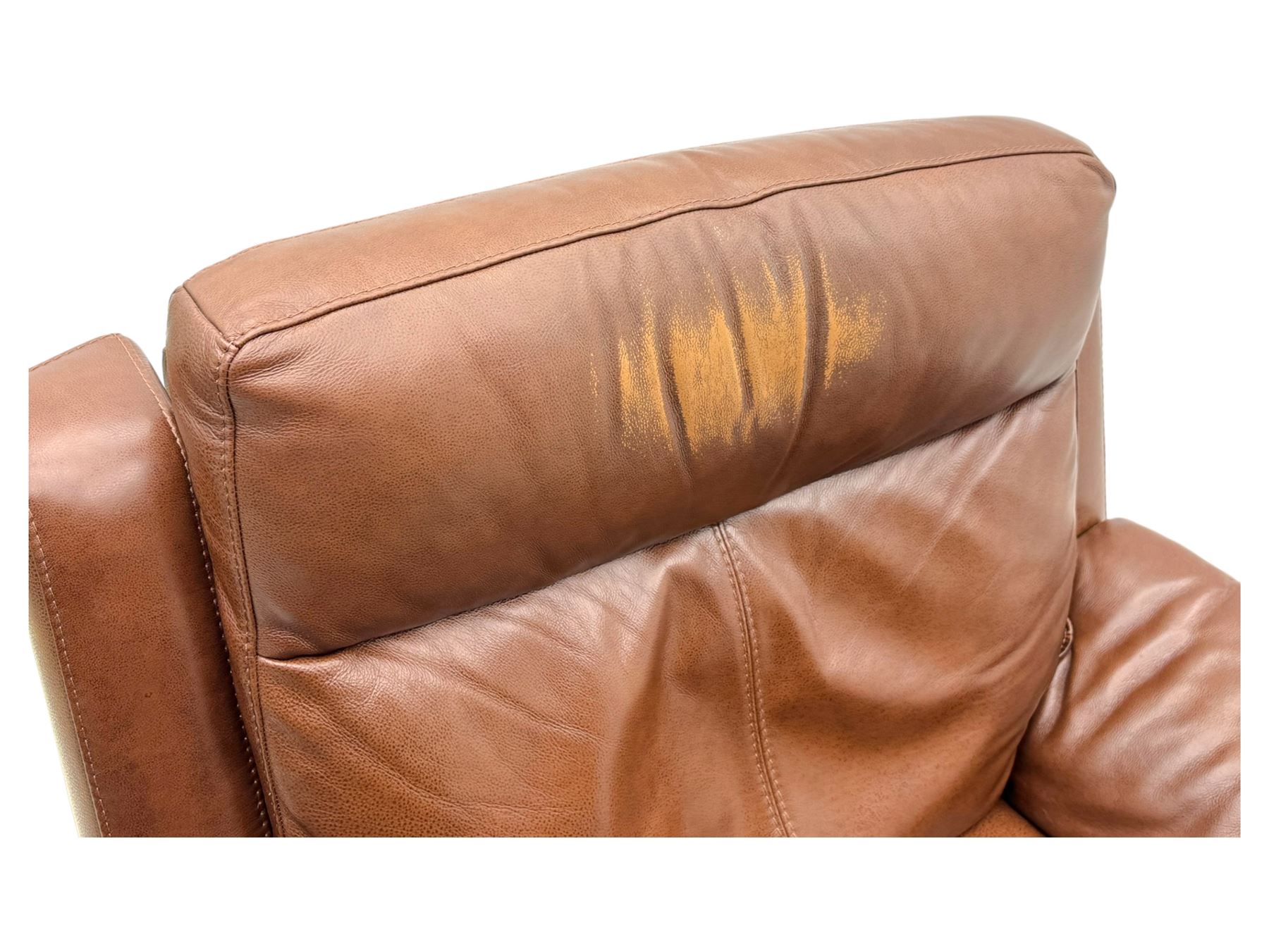 DFS - 'Liaison' reclining armchair upholstered in brown leather, upholstered in tan leather with stitched panel backrest and generously cushioned seat and arms, operated by wired remote, raised on block feet