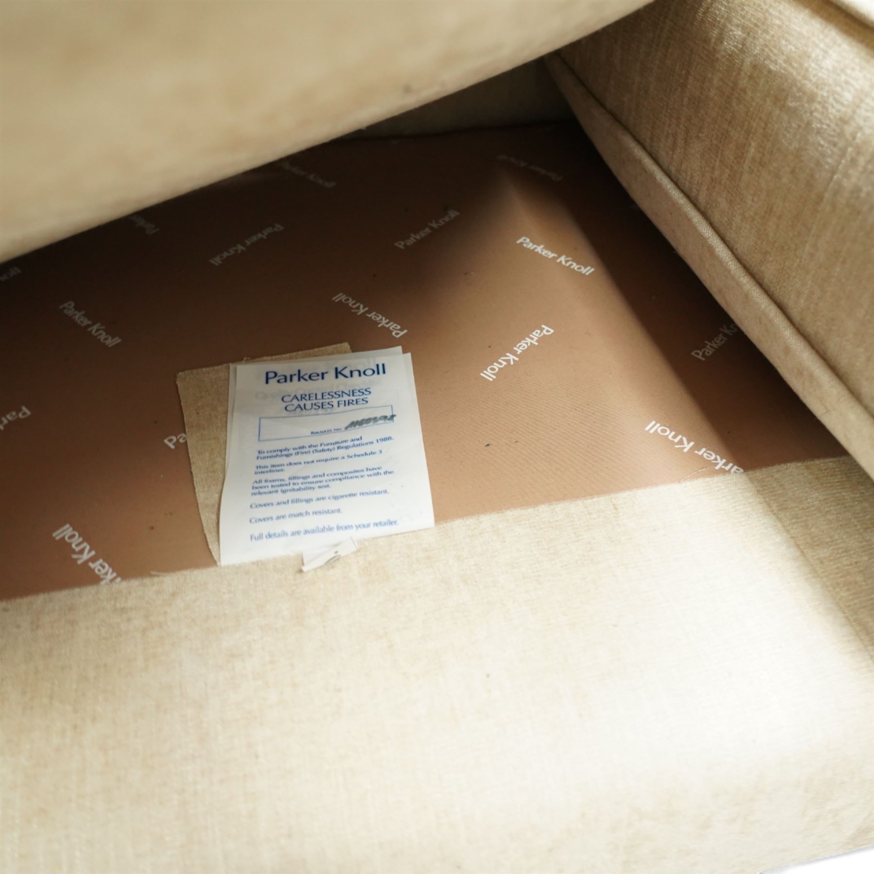 Parker Knoll - contemporary beige upholstered two seat sofa, with flared scroll arms and loose back and seat cushions, standing on stained tapered block feet