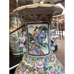 Large pair of 19th century Cantonese famille rose vases, each painted with various courtly scenes, including a display of warriors fighting on horseback before an official and his attendants, double Buddhist lion handles and applied at the shoulders with chilong, the lower band painted with Greek key motif, H58cm (2)