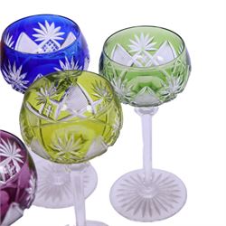 Set of six 20th Century Val St Lambert Berncastel style crystal glass wine glasses, in yellow, greens, red, purple and blue, flash cut with a repeat diamond and plume pattern above a knopped cut stem and circular spread foot, H18cm