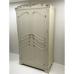 Late 20th century French style white and gilt double wardrobe,  shell carved cresting rail, two doors enclosing fitted interior, shaped bracket supports