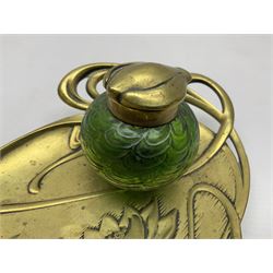 Art Nouveau Geschutzt brass desk stand, with stylised whiplash relief decoration, with removable Loetz style green glass inkwell, stamped to the base, H8cm