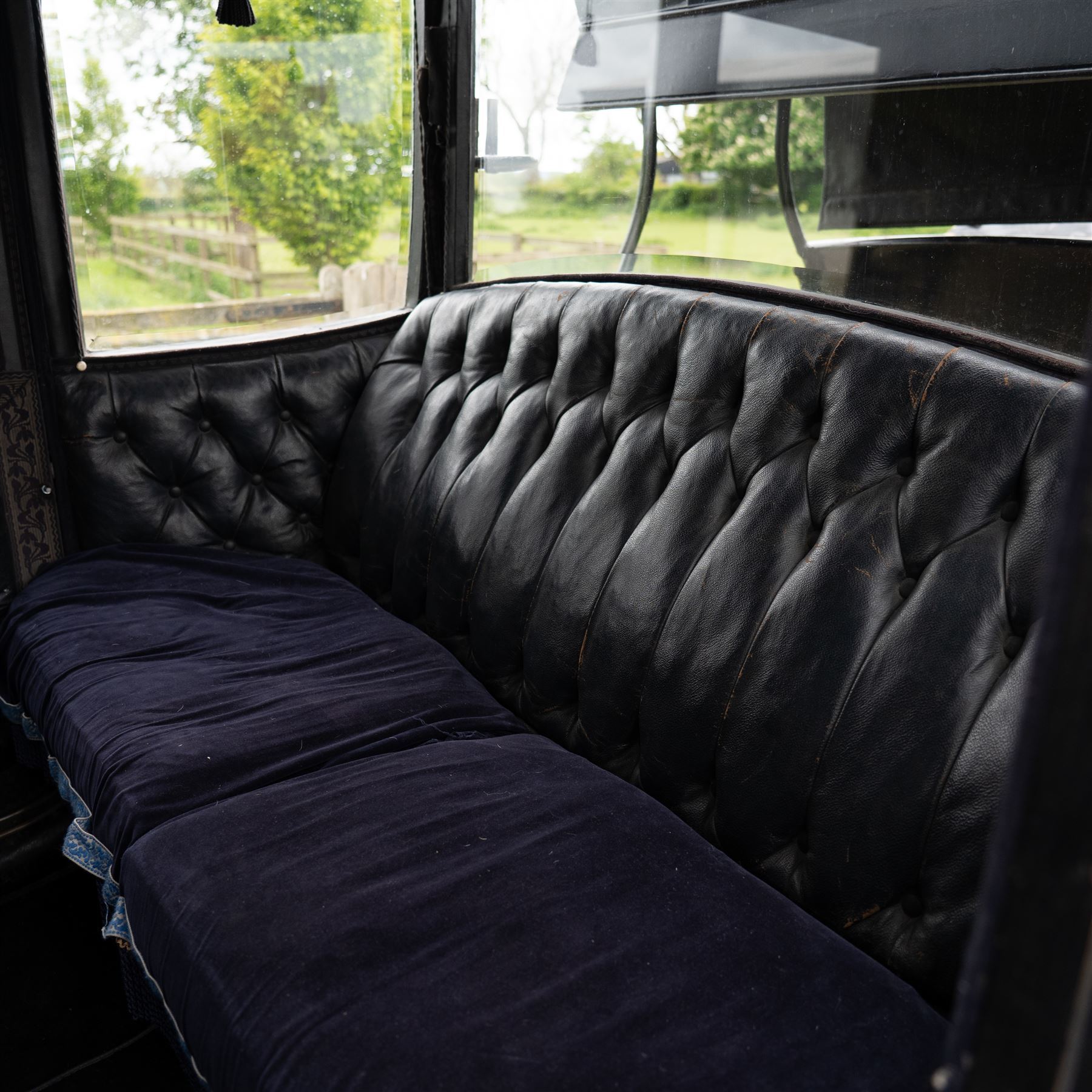 Town Coach by John Marstons Birmingham - Ex Film

A black painted five glass Town Coach by John Marston's Carriage Works Ltd, Birmingham, with enclosed glazed passenger compartment, curved front glass, external coachman's box seat and pole for driving with a pair of horses. The carriage has a timber coach body with buttoned black leather interior, blue upholstered seat cushions, plated exterior door handle, maker plates to the body and step, and John Marston marked hub caps. Mounted on black painted wooden spoked wheels with rubber tyres, leaf spring suspension, underbody turntable steering and iron fittings throughout.
Featured on the film set of 'Victoria' with Jenna Coleman

Features

• Black painted enclosed coach body
• Glazed passenger compartment with five windows
• Curved front glass
• Buttoned black leather interior
• Blue upholstered seat cushions
• External coachman's box seat
• Timber coach body
• Wooden spoked wheels
• Rubber tyres
• Leaf spring suspension
• Underbody turntable steering
• Pole for pair of horses
• Iron foot steps
• Plated exterior door handle
• Maker plates for John Marston's Carriage Works Ltd, Birmingham
• John Marston marked hub caps
• Featured on the film set of Victoria with Jenna Coleman

Dimensions:
Overall length: 390 cm
Width: 190 cm
Height: 214 cm

Wheel Diameters:
Front wheels: 104 cm
Rear wheels: 134 cm

Seating:
Coachman's box: 2
Passenger compartment: 4