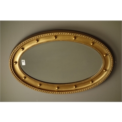  Oval gilt framed mirror (74cm x 50cm), Art Deco frameless mirror and two bevelled mirrors with metal decoration   