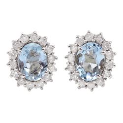 Pair of 18ct white gold oval aquamarine and round brilliant cut diamond cluster stud earrings, stamped, total aquamarine weight approx 1.70 carat,, total diamond weight approx 0.60 carat