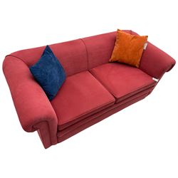 Two seat Chesterfield sofa, upholstered in salmon fabric, on turned bun feet