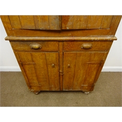  Early 20th century stained and grained pine kitchen cabinet, projecting cornice, two doors above two drawers and two cupboard doors enclosing shelves, turned supports, W102cm, H207cm, D57cm  