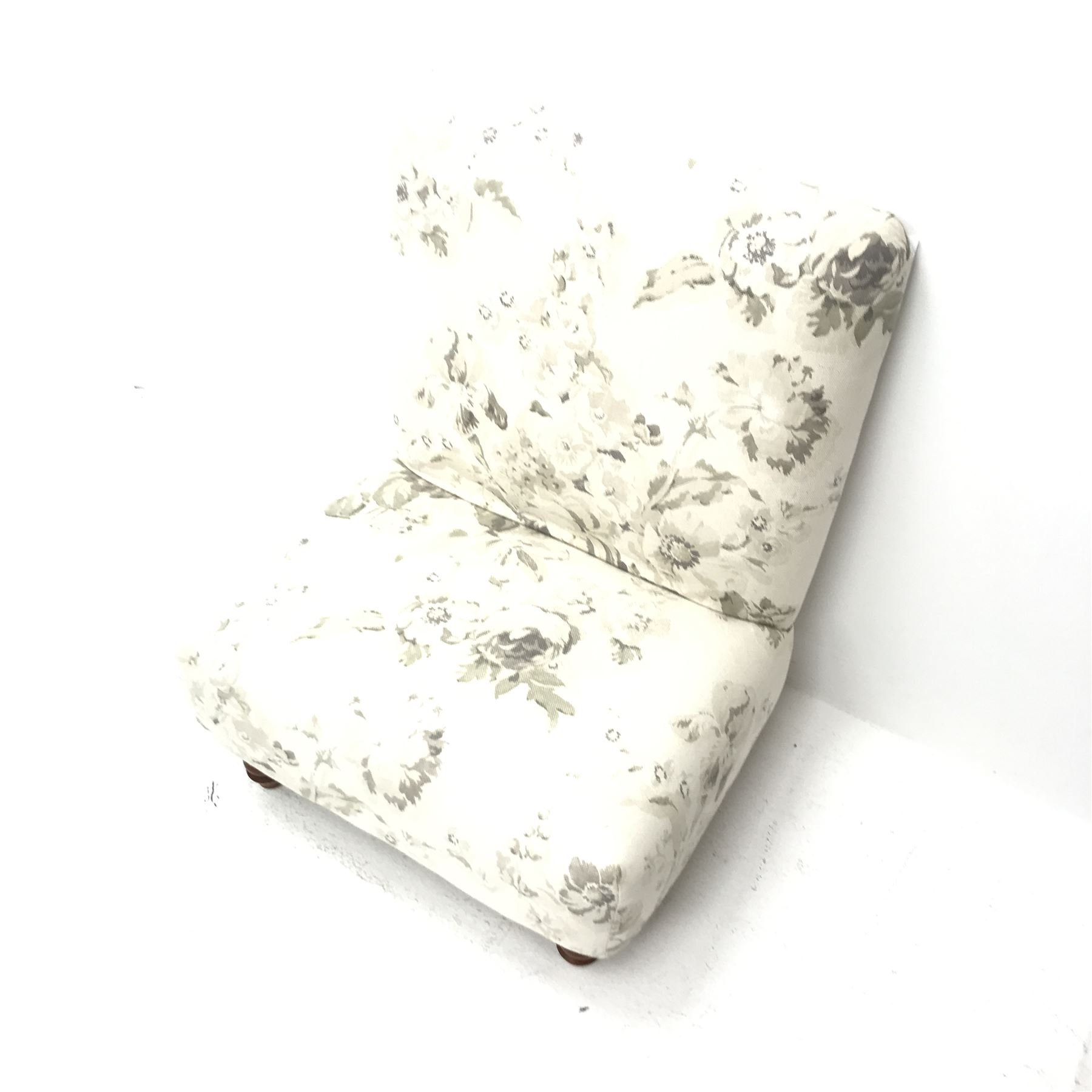 Wide seat nursing chair upholstered in an ivory ground fabric with floral pattern, turned supports, W63cm