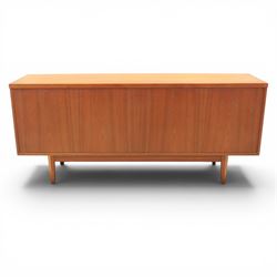 Mid-20th century teak sideboard, rectangular top above four frieze drawers with recessed handles, flanked by two cupboard doors with fall front central media cupboard