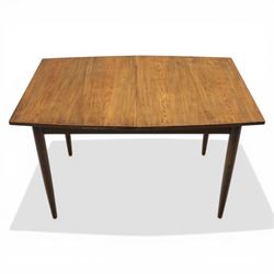 Ensign - Mid-20th century elm extending dining table, with fold out leaf, bow ends and sides; and four low stick back chairs, labelled Ensign Bristow & Townsend Ltd, extended 168cm