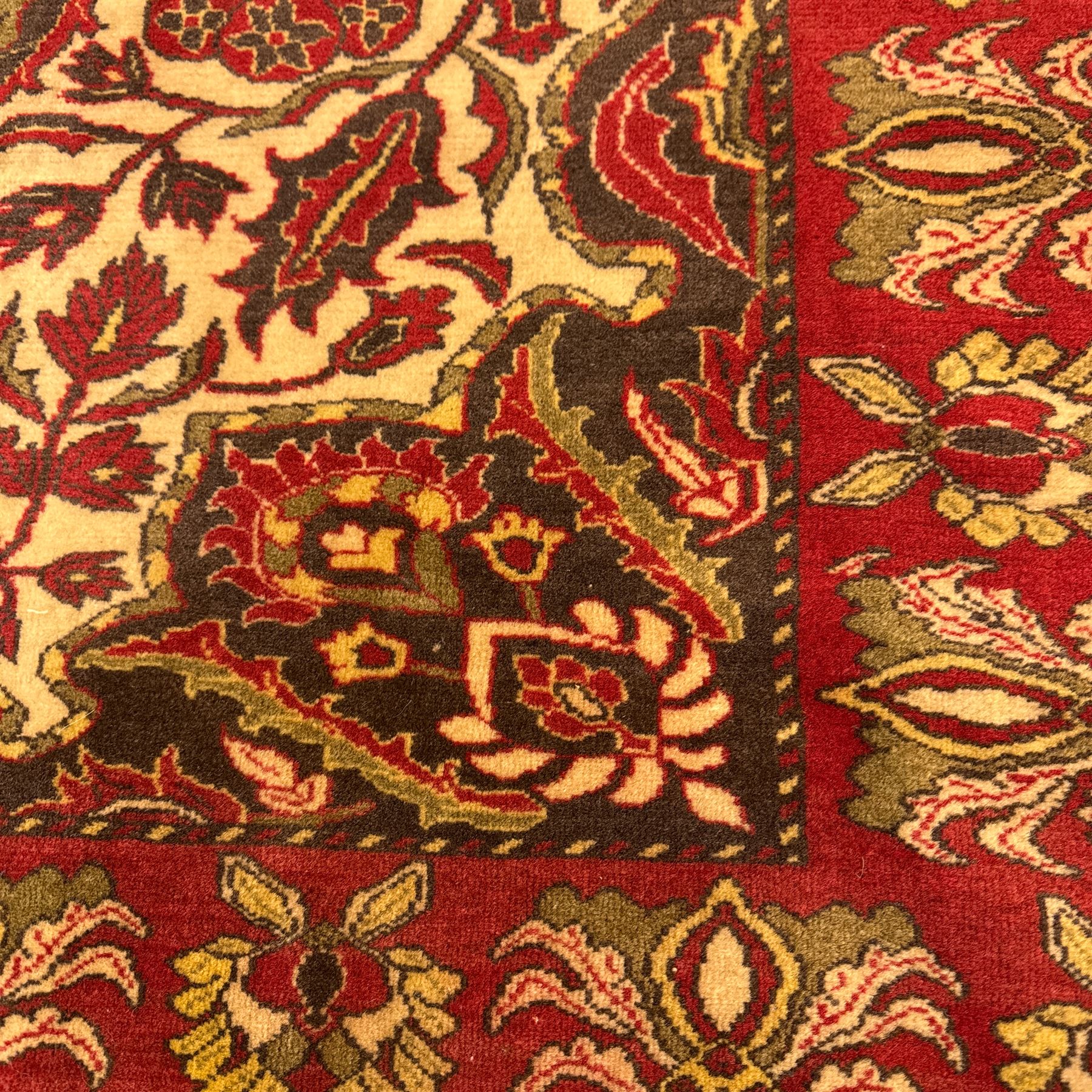 Persian Kerman hand-knotted rug, ivory and crimson ground, central medallion surrounded  by a floral foliate pattern, main border with repeating design of floral cartouches and palmettes, and narrow vine work guard border  