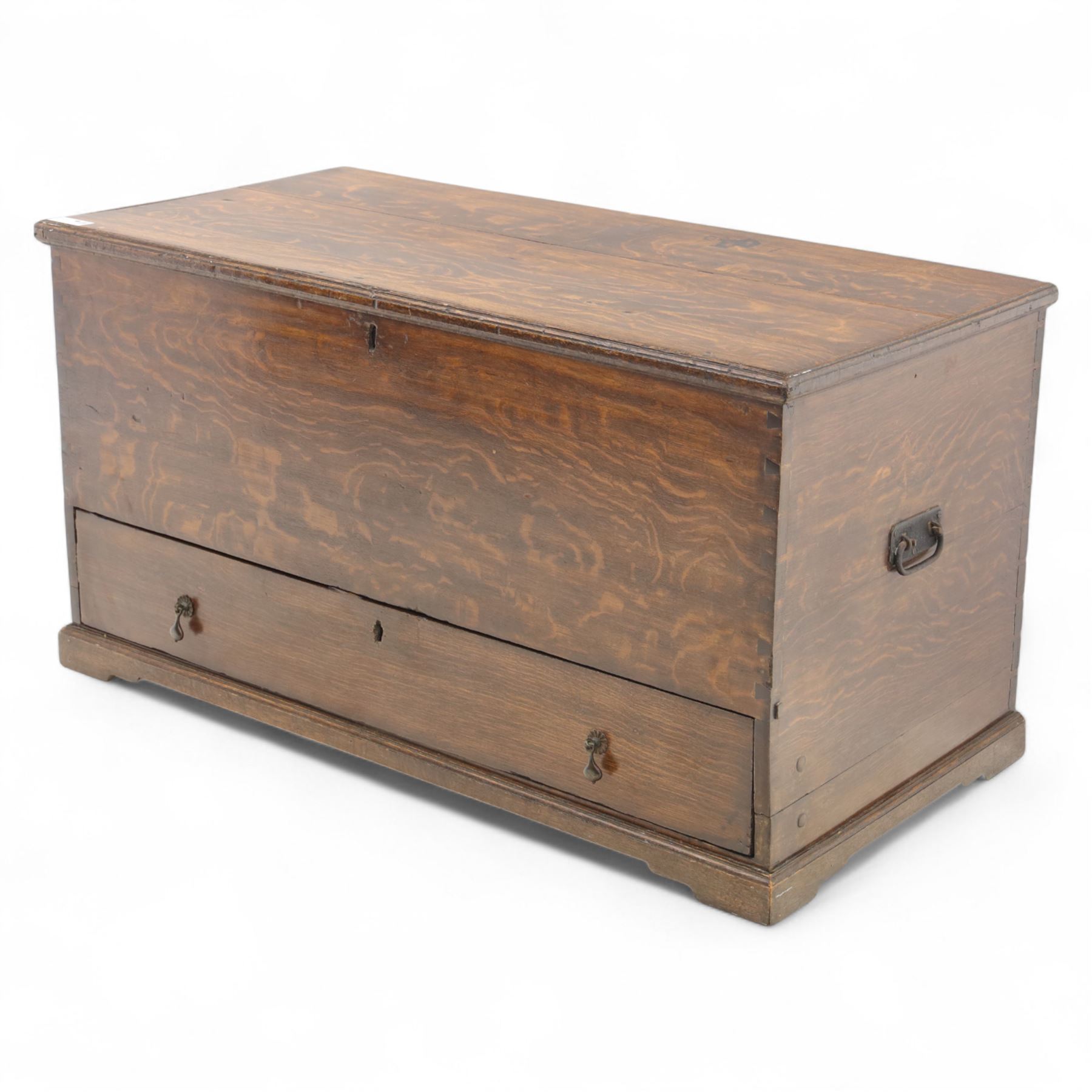 19th century oak blanket chest, rectangular hinged plank top with moulded edge, plain sides fitted with iron carrying handles, single full-width drawer to base with brass drop handles, on moulded plinth base