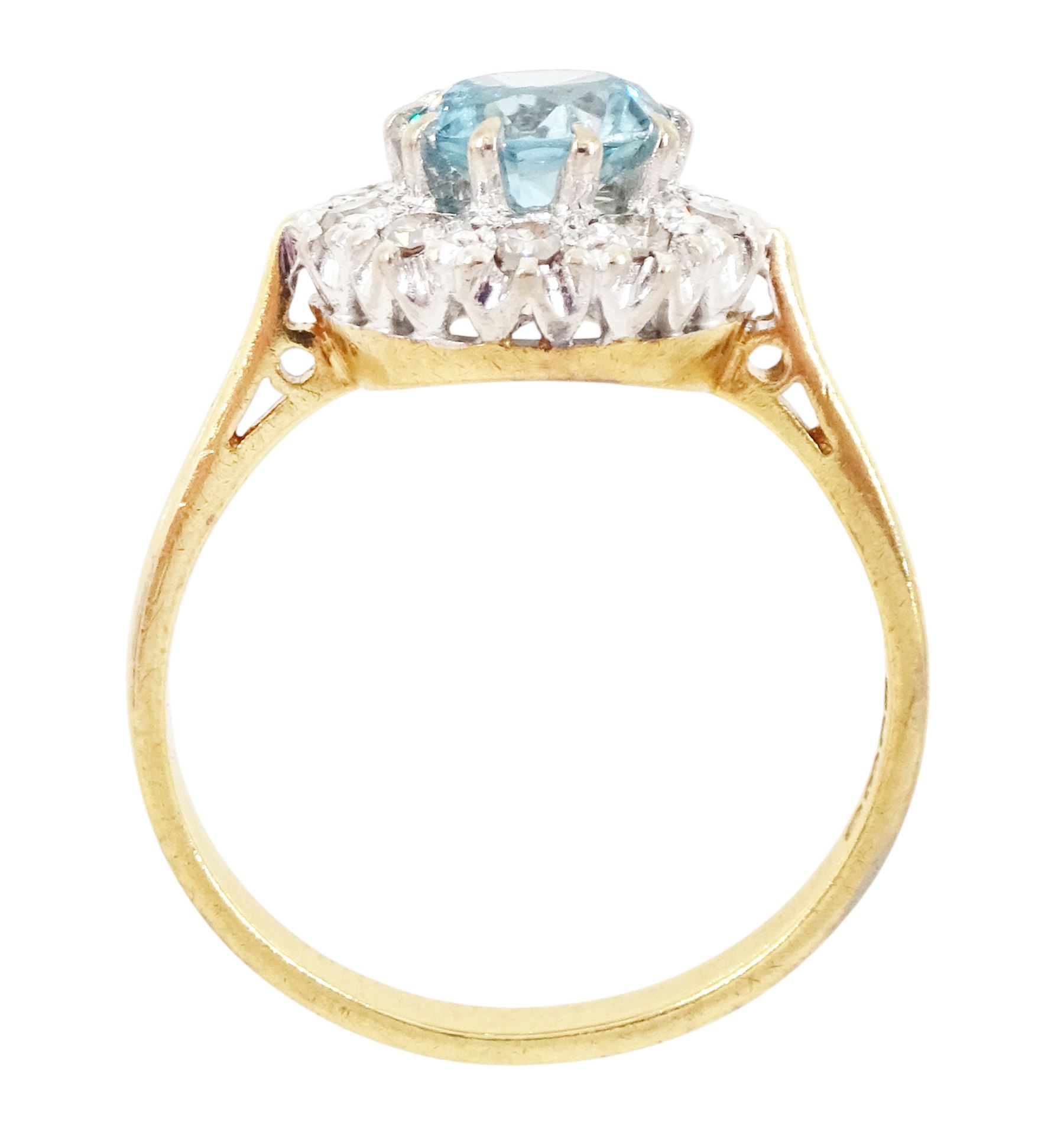 18ct gold blue zircon and diamond cluster ring, single round cut blue zircon surrounded by ten single cut diamonds, London 1965