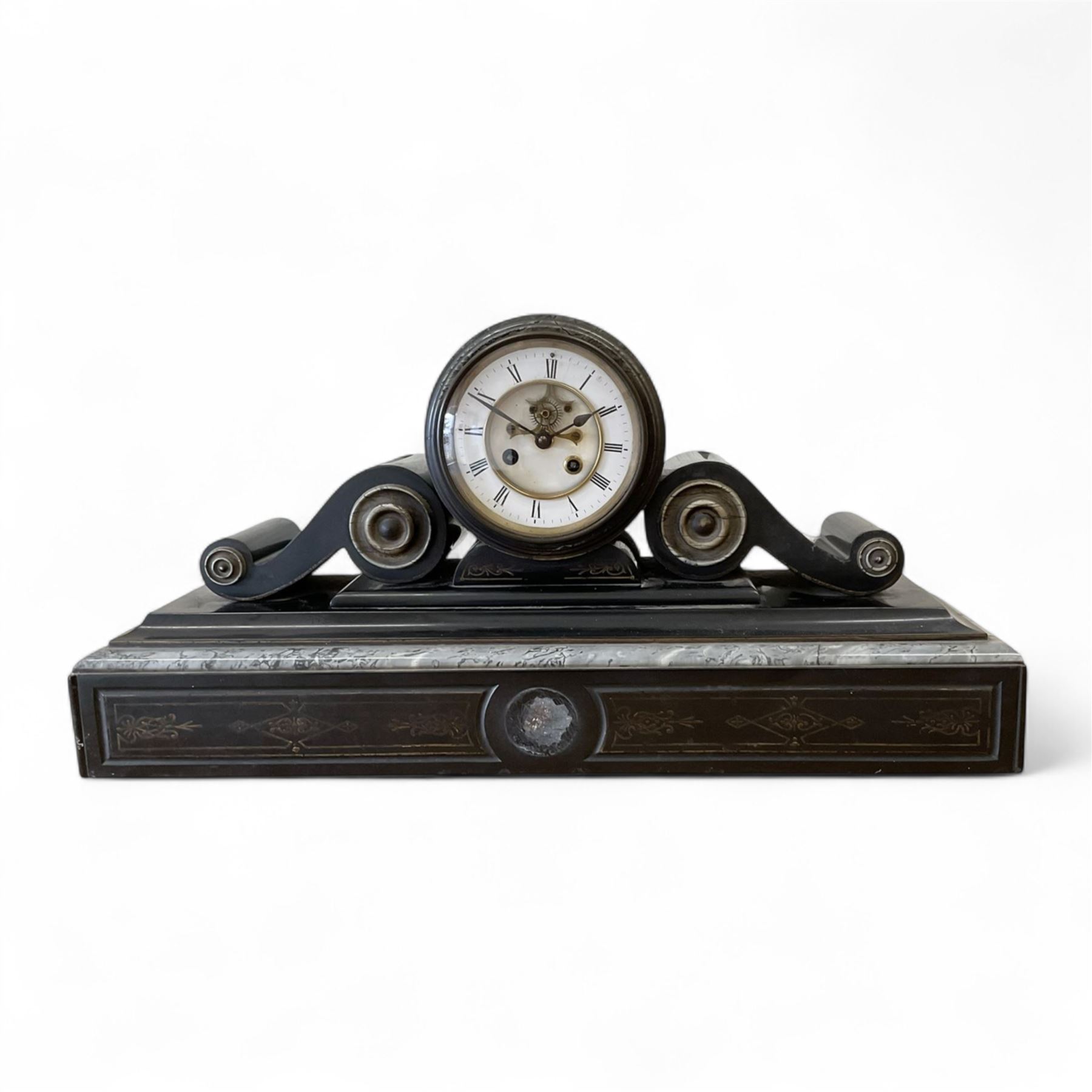 French- late 19th century 8-day Belgium slate and marble mantle clock, drum movement with volutes and conforming scroll side pieces, on a stepped plinth with incised decoration to the front, two-piece enamel dial with a visible Brocot deadbeat escapement, spade hands and Roman numerals, twin train, countwheel striking movement, sounding the hours and half-hours on a bell. With pendulum and key. 