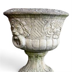 Pair of classic design cast stone garden urns, circular bowl detailed with lion mask loop handles