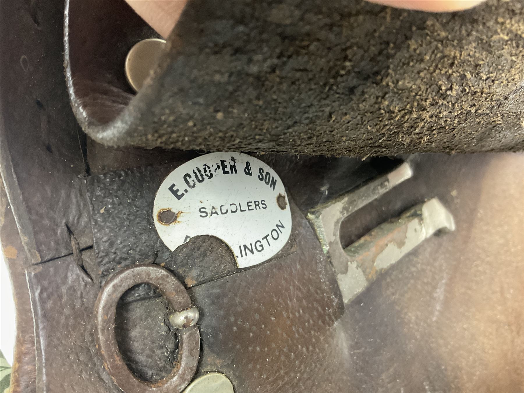 Collection of nine saddles, mainly havana leather to include a racing saddle and a Goodwin saddle, some with stirrups and leathers 