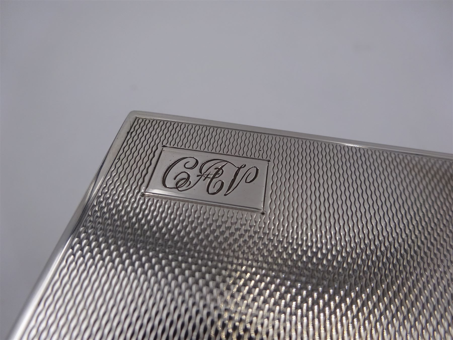 1930s silver mounted glass inkwell, of square form, the silver lid with engine turned decoration and engraved initials, hallmarked Adie Brothers Ltd, Birmingham 1937, H4.7cm