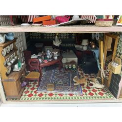 Kit-built large wooden dolls house, modelled as a double-fronted, four-storey town house, with double-hinged front facade opening to reveal a fully furnished interior with two rooms to first three floors and attic room to top floor, wired for electric lighting, with detachable garden room, garden furniture and accessories, house W57.5cm, H85cm, D35cm