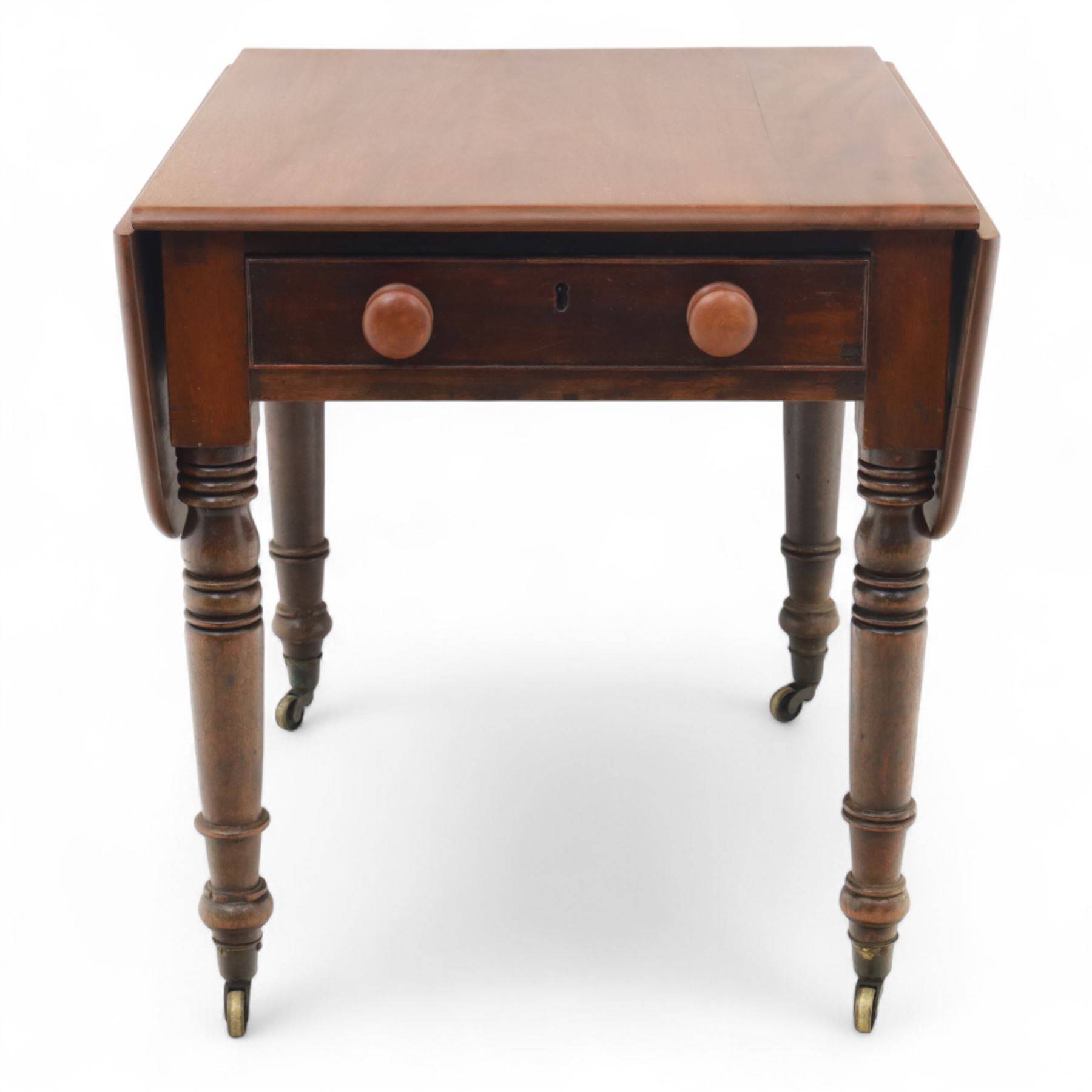 Mahogany drop-leaf Pembroke table circa 1900, with rounded rectangular top and single frieze drawer, raised on turned and tapered supports with brass castors (Extended 128cm)