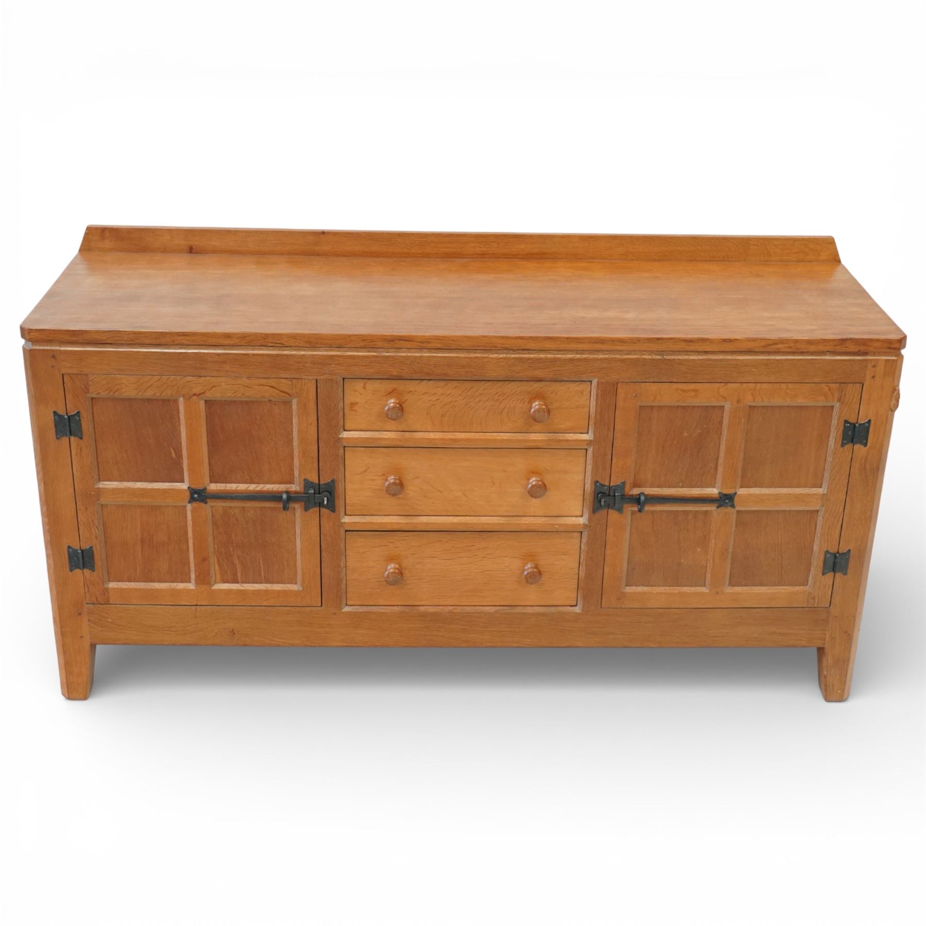 Rabbitman - oak sideboard adzed top with galleried top, with three graduating drawers to the centre, flanked by two panelled and lightly adzed doors, iron latches and hinges, raised on tapered stile supports, with carved rabbit signature, by Peter Heap of Wetwang   