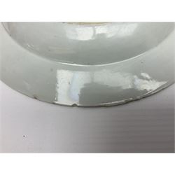 Three 18th century Chinese Famille Rose plates, the first example enamelled with blossoming peonies, rockwork and fence, the other two examples of similar design, decorated with blossoming peonies and sprigs within shaped inner borders, each approximately D23cm