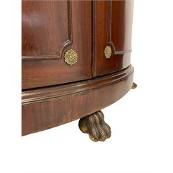 Pair of French Empire design corner cabinets, the straight-front upper section with canted corners and applied half-column pilasters, enclosed by mirror glazed door, the bow-front lower section enclosed by two doors with applied mouldings, mounted by cast metal floral rosettes, skirted base with cast gilt metal hairy paw brass feet