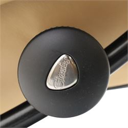 Ekornes Stressless - beech framed reclining swivel armchair with matching footstool, on U-shaped supports with circular bases, upholstered in beige leather