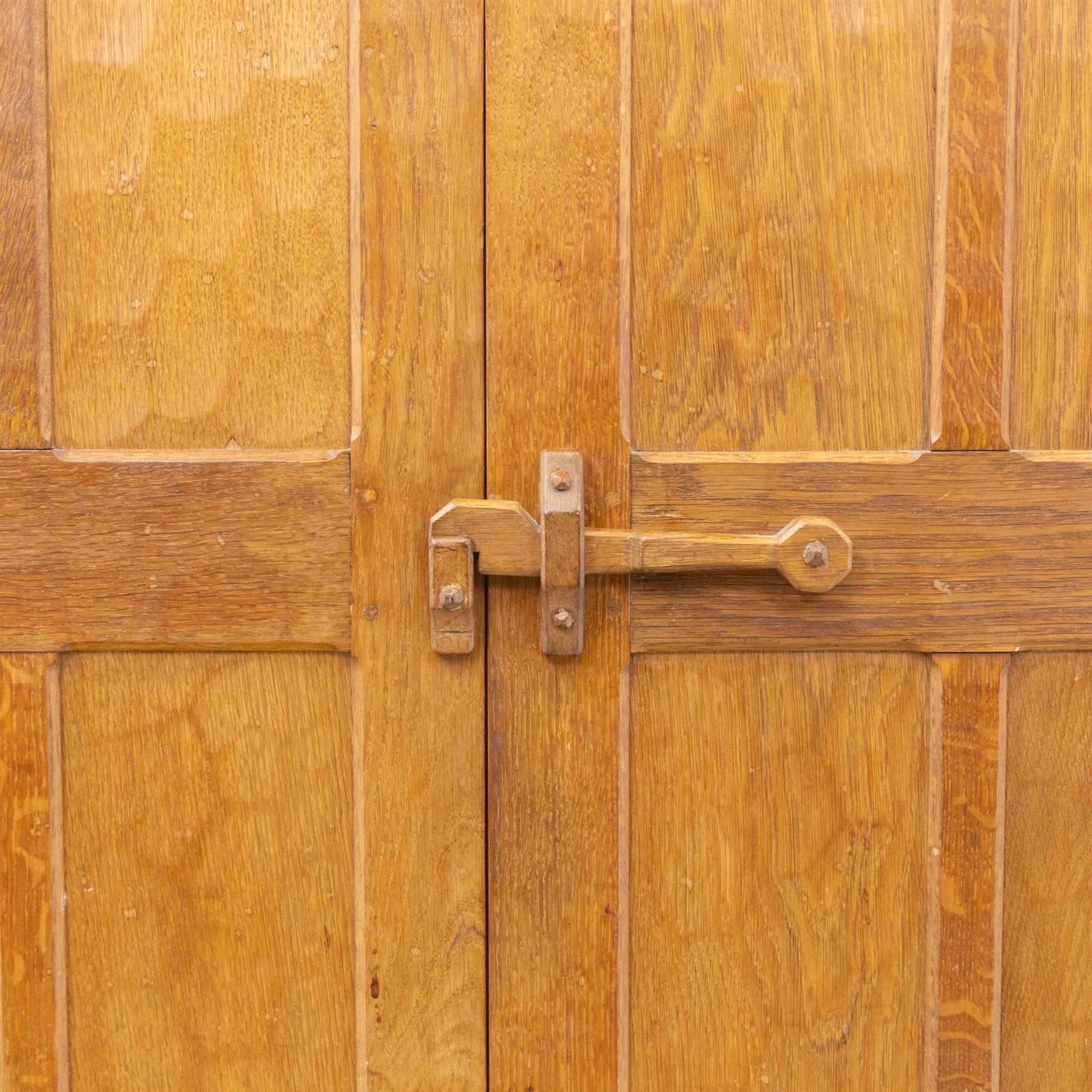 Acornman - oak adzed panelled double wardrobe, with wrought iron hinges and carved oak latch revealing a single clothes rail, with signature carved acorn to top right, by the workshop of Alan Grainger, Brandsby