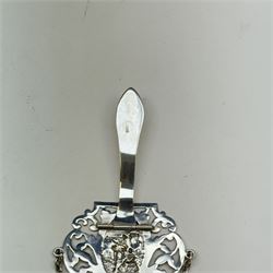 Victorian and later silver chatelaine, the shaped and foliate pierced clasp with embossed oval panel of a courting couple, hallmarked Levi & Salaman, Birmingham 1899, supporting six accessories on five chains: a circular mirror embossed with putti, hallmarked Henry Matthews, Birmingham 1911, pencil holder engraved with foliate scrolls, hallmarked Francis Webb, Birmingham 1914, conical scent bottle decorated with bamboo, (unmarked but testing as silver), aide memoire embossed with putti, hallmarked Samuel M Levi, Birmingham 1911, tape measure of compressed spherical form, hallmarked Henry Matthews, Birmingham 1899, and a purse with embossed putti, hallmarked Birmingham 1909, makers mark worn and indistinct, at longest point L31cm

