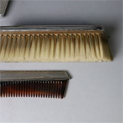Mid 20th century silver mounted dressing table set, comprising hair brush, clothes brush, hand mirror and comb, each with engine turned Art Deco style decoration, all hallmarked Walker & Hall, Sheffield 1954 &1955