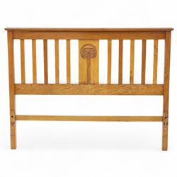 Art Nouveau oak double bed headboard, rectangular form with vertical slats centred by a carved stylised floral roundel