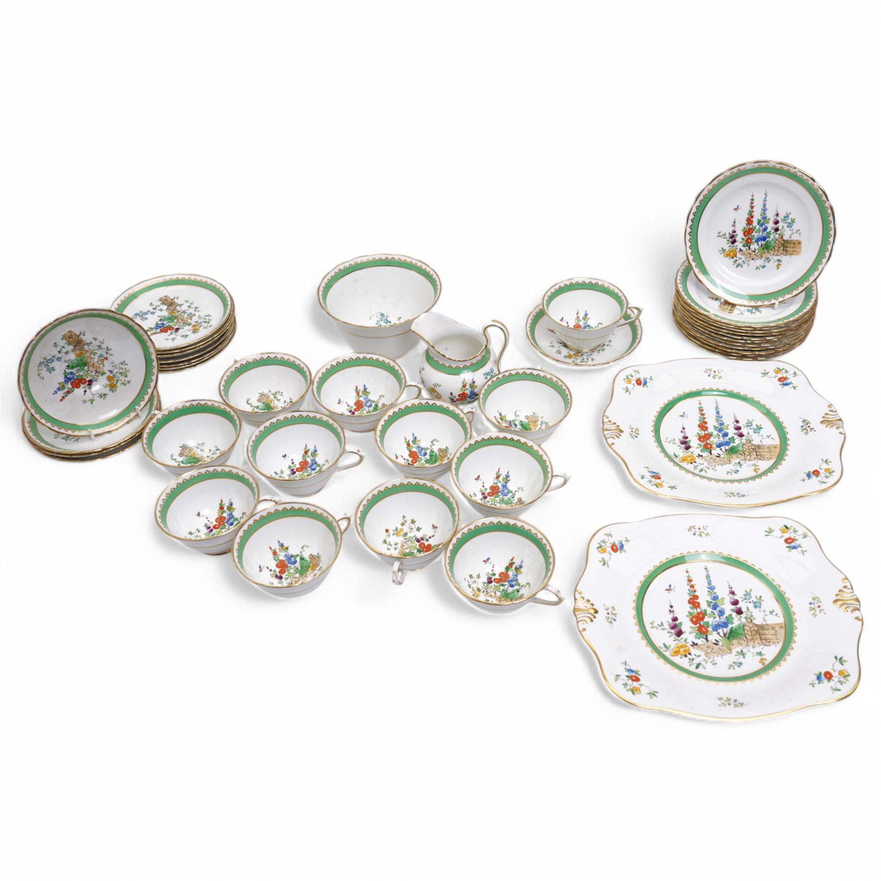 1930s Plant & Co Tuscan china tea set painted with flowers in blue, pink etc within a green border comprising twelve cups and saucers, twelve plates, two bread and butter plates, milk jug and sugar bowl (40)