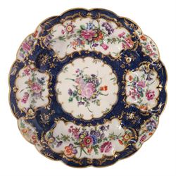 Pair of Worcester junket dishes, c1770, painted with panels of flowers on a blue scale ground within richly gilt rococo style borders and scalloped rim, hatched square mark to base, D24.5cm (2)
Notes: label suggests provenance relating to the Brownlow family of Belton House.