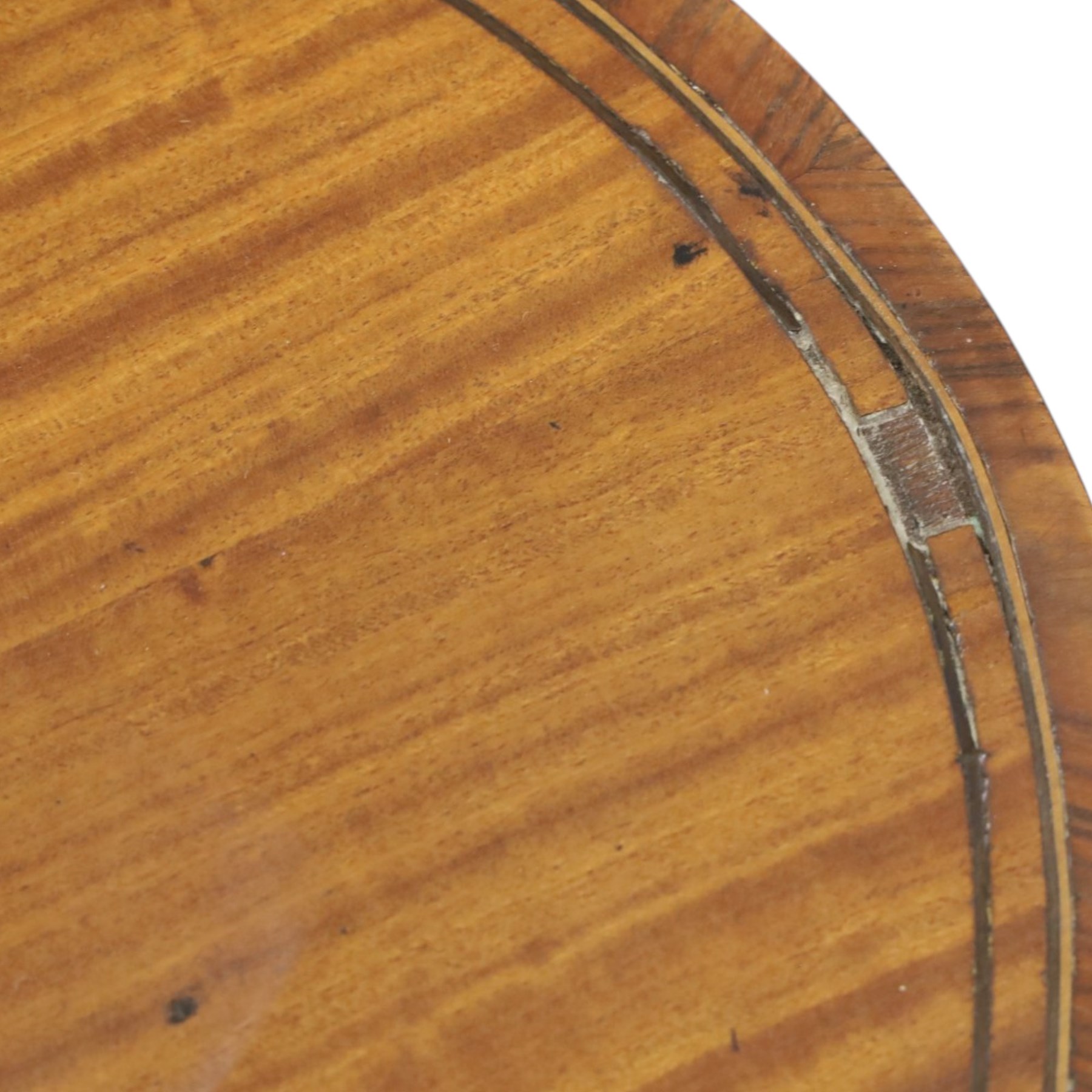 Edwardian inlaid satinwood oval sewing or work table, crossbanded and ebony-strung hinged top enclosing fitted compartment and olive-green upholstered well, raised on square tapering splayed supports united by under-tier 