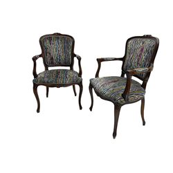 Pair of French design open armchairs, the moulded frame carved with flower heads, upholstered seat, back and arms, on cabriole supports