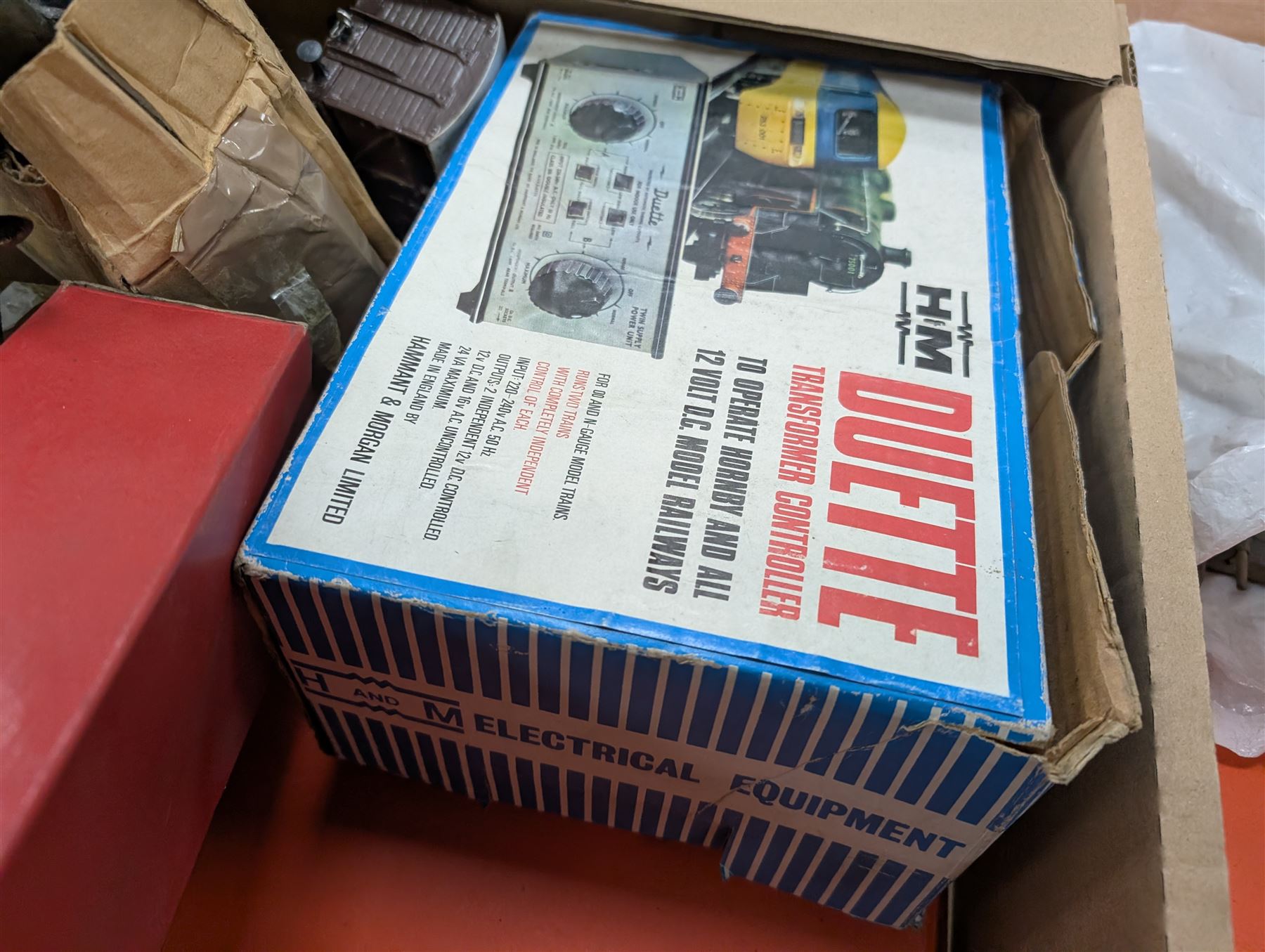 Hornby 'O' gauge 42380 No.2 Turntable, 43063 Points and 42320 No. 1 Level Crossing, all boxed, together with two tin plate passenger coaches, Hornby 'O' gauge LMS tender, three plastic 'O' gauge wagons, Hornby mechanisms, HM Duette Transformer Controller and other accessories