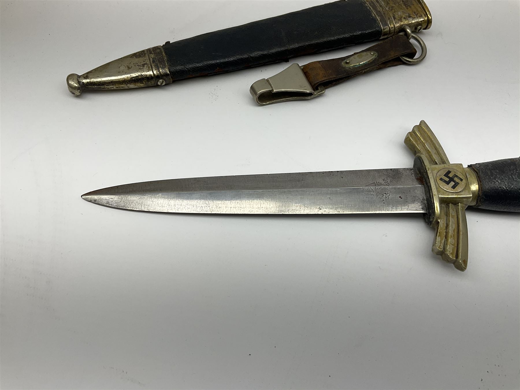  WW2 German SMF Solingen DLV flyers dagger with 16cm steel blade, nickel downswept cross-piece and pommel and leather covered grip, in leather and nickel scabbard with leather suspension strap L34cm overall. After WWI Germany was forbidden an air force by the Treaty of Versailles however the Deutscher Luftsport-Verband (German Air-sport Association) was formed in March 1933 from various sports flying clubs and had branches for aeroplane, gliding and balloon flying. Under cover of the sporting DLV, many future Luftwaffe pilots trained to fly. DLV was embodied with the NSKK in March 1935 and 1st March 1937 Luftwaffe formed.