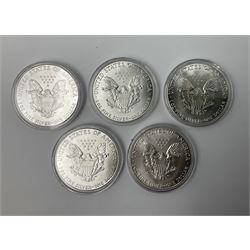 Five United States of America 1oz fine silver one dollar coins, dated 1986, 1987, 1988, 1989 and 1990