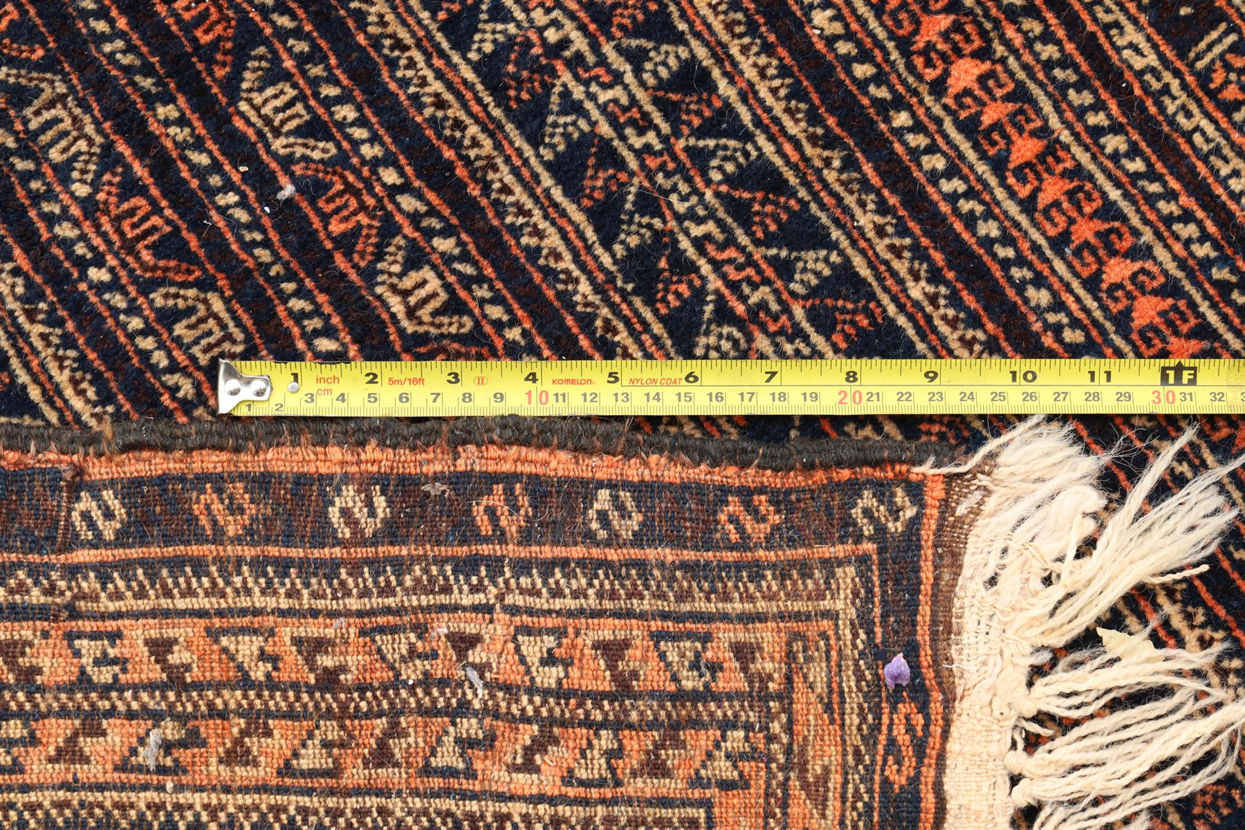 North Persian indigo ground tribal rug, the field decorated with stylised geometric motifs within vertical rows, the guard stripes with repeating hook motifs