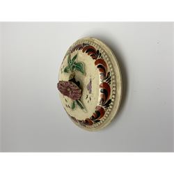 18th century creamware teapot, probably Leeds, with reeded entwined handle and floral finial to the cover, the body with hand painted polychrome decoration of figure to one side, and floral spray to the other, collectors paper label beneath inscribed Leeds Pottery, H11.5cm