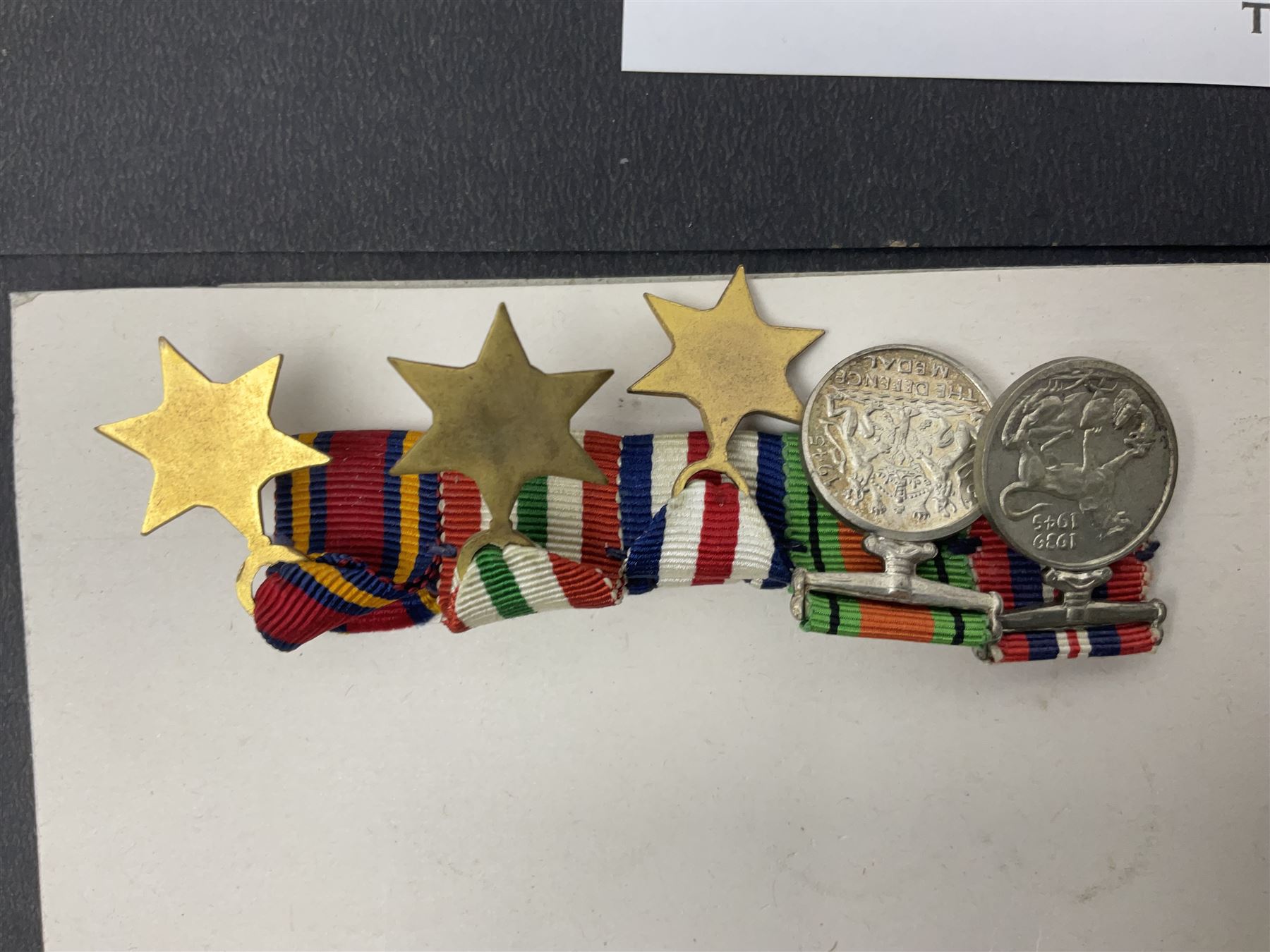 Representative display of WWII Campaign Stars and Medals comprising Burma Star, Italy Star, France & Germany Star, Defence Medal and War Medal 1939-1945; together with the corresponding group of miniatures; all with ribbons