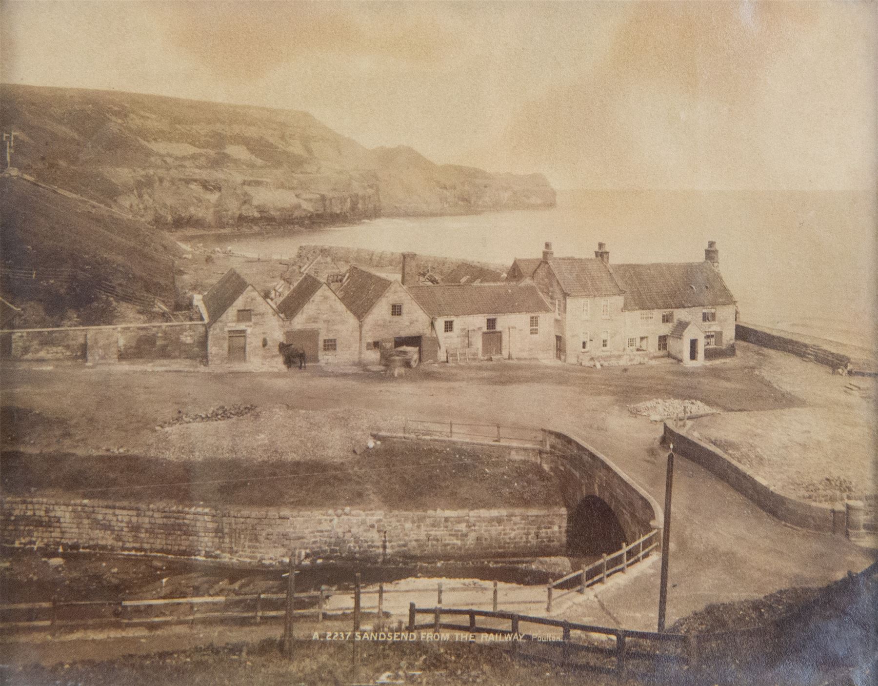 After Frank Meadow Sutcliffe (British 1853-1941): 'Pier Road Whitby', photographic print with facsimile signature 34cm x 44cm; 'Sandsend from the Railway', 19th/early 20th century photograph pub. Poulton No.A.2237, 14cm x 18cm (2) 