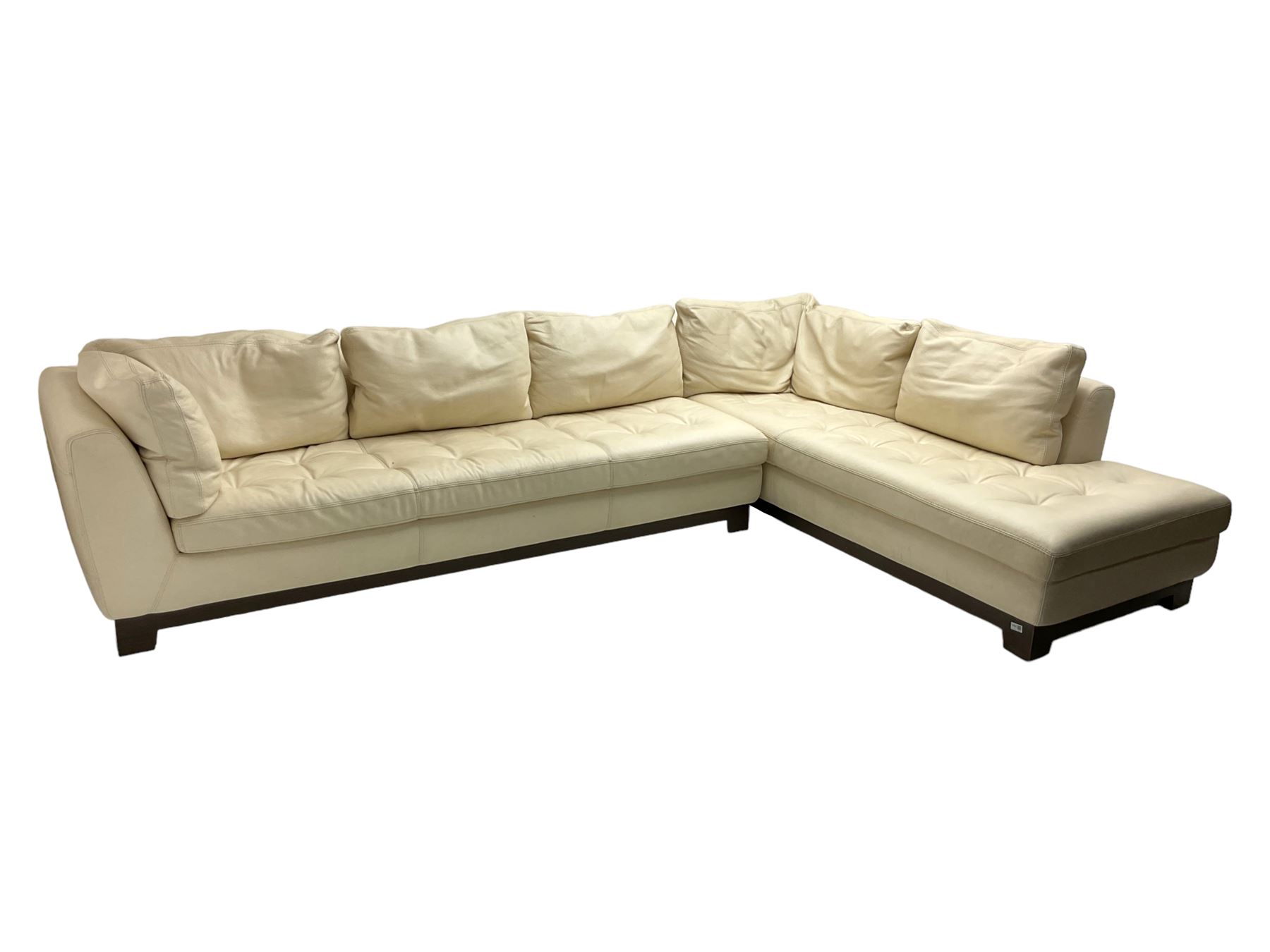 Roche-Bobois - large corner sofa, upholstered in ivory leather with buttoned seat cushions, raised on a stained beech base with bracket feet