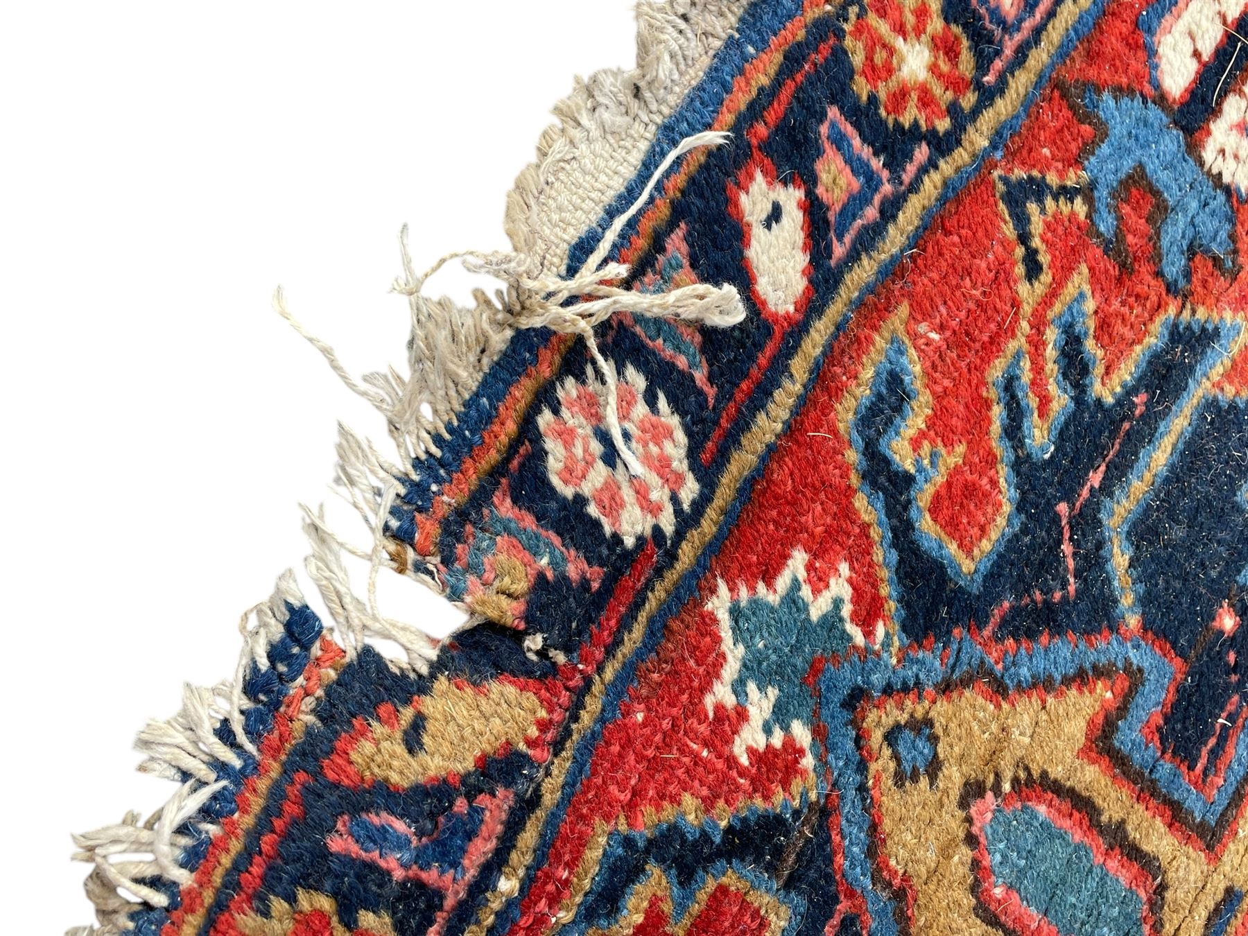 Persian blue ground carpet, the field divided up into panels by trailing bands with flower heads, each panel decorated with palmettes and stylised plant motifs, the border decorated with further palmettes, within floral pattern guard stripes 