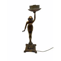 Art Deco style bronzed table lamp, modelled as a semi nude female figure, her arm raised supporting the fixture, upon stepped square base, overall H40cm