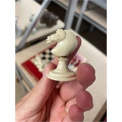 19th century walnut and brass bound games compendium box, painted to enhance the grain, of rectangular form, the hinged opening cover with rounded sides, central brass cartouche with engraved lion crest, and brass riveted straps, opening to reveal a red leather and blue silk lined compartmented interior, with fold-down games board, and lift-out tray containing playing cards, ebony turned dice towers, white and red stained bone draughts, and chess pieces, ivory dice, and ivory and ebony whist markers, and brass bezique board, cribbage board and markers, H15cm W32cm D24cm
This lot has been registered for sale under Section 10 of the APHA Ivory Act